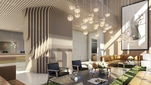 Un interior moderno con un diseño de techo único, una zona de estar con una mesa de centro y una gran obra de arte enmarcada en la pared.