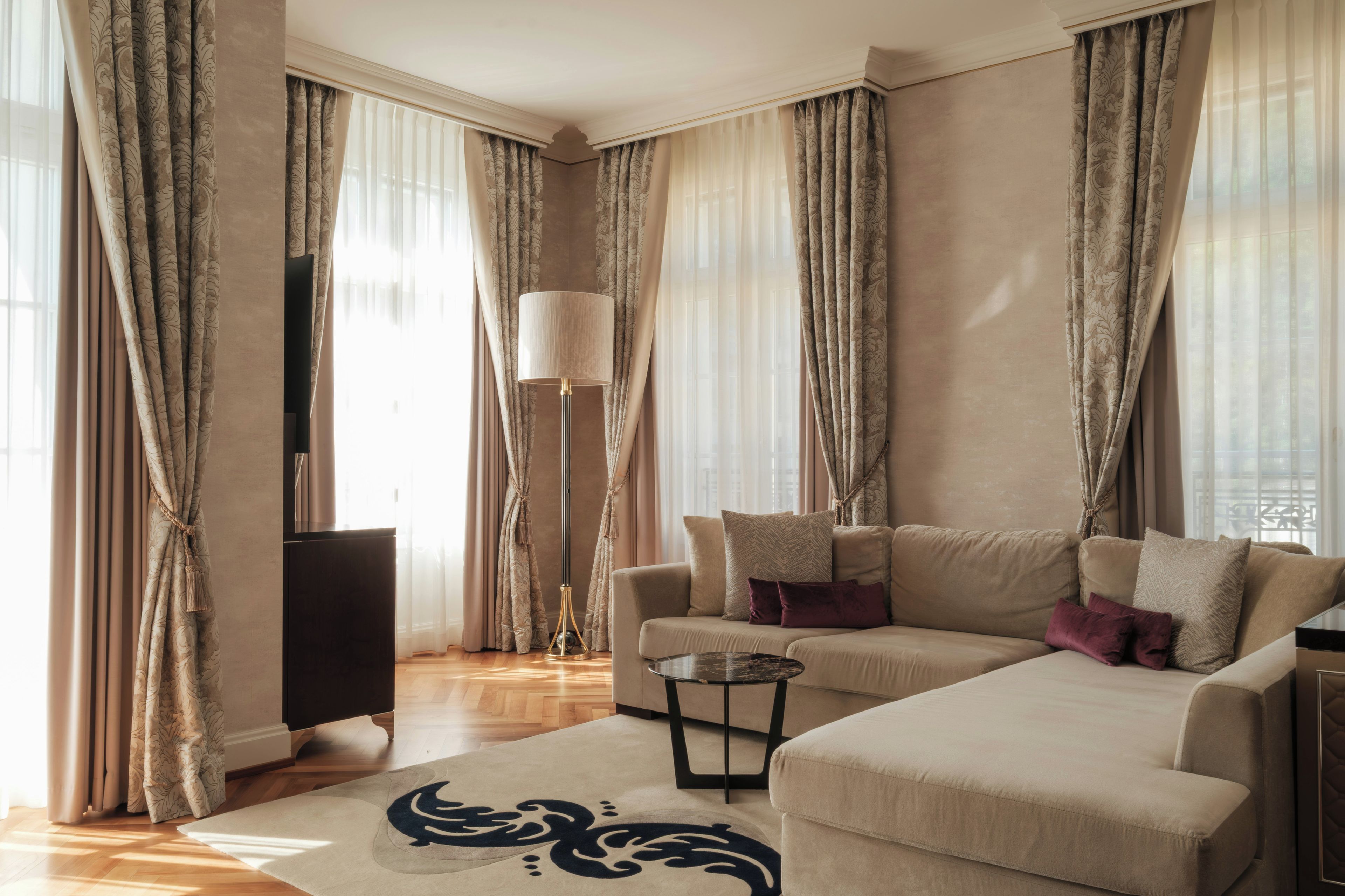 A modern living room with a sofa, a floor lamp, and a television.