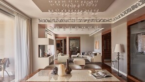A modern dining area with a wooden table, chairs, and a chandelier.