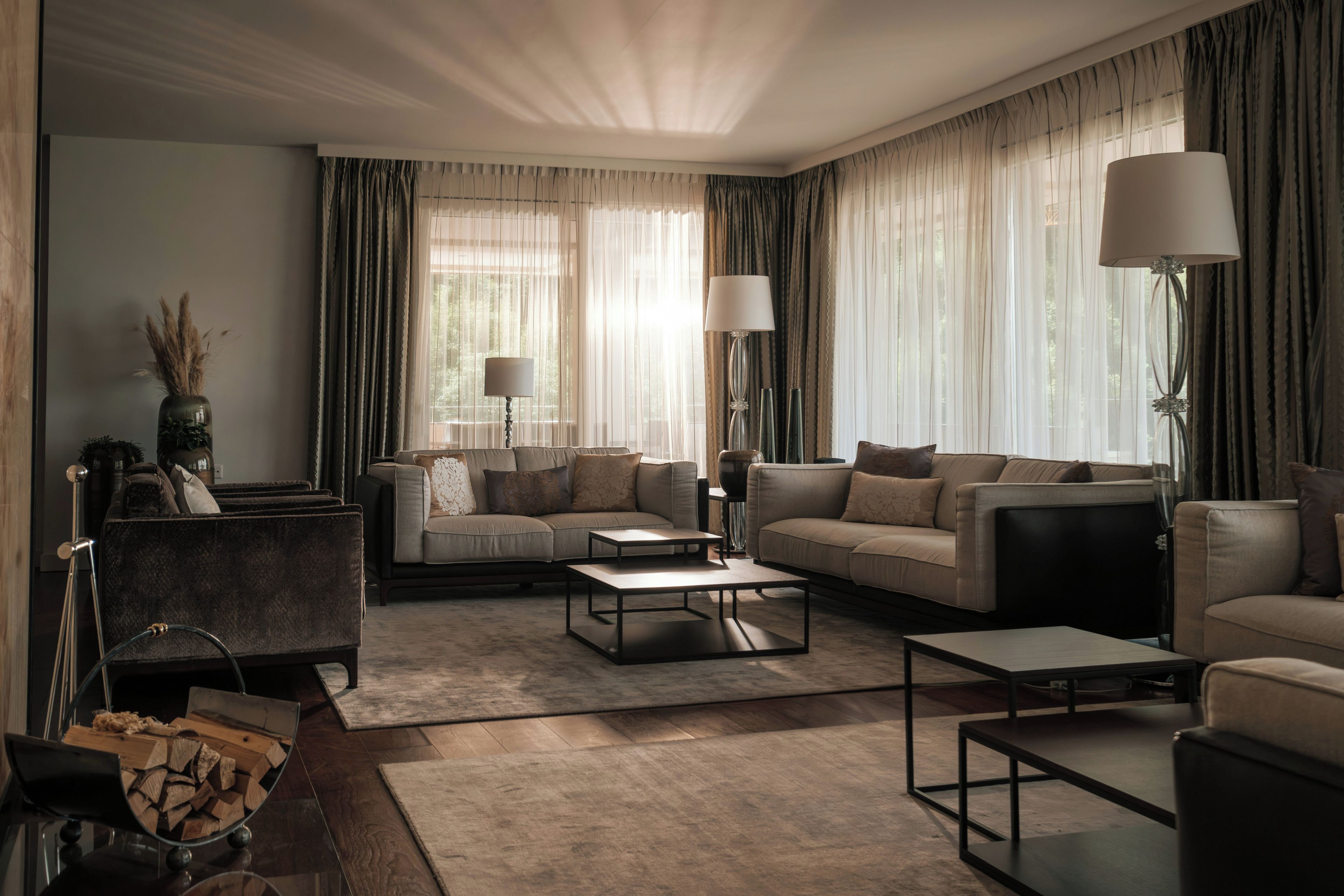 A modern living room with a sofa set, two side tables, and a coffee table.