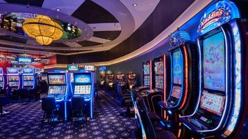 Experience the excitement of the casino floor, where rows of slot machines await your luck.