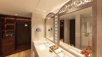 A modern bathroom with two sinks, a large mirror, and a vanity with storage.
