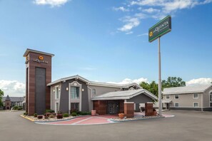 A La Quinta hotel with a modern design, a prominent entrance, and a clear sky. - La Quinta Inn by Wyndham Omaha West (Omaha)