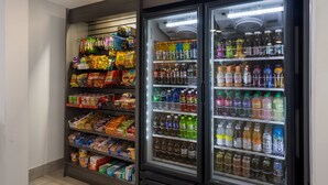 A vending machine stocked with snacks and beverages.