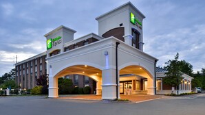 A Holiday Inn Express hotel with a modern design, featuring a prominent entrance and multiple levels. - Holiday Inn Express Winston-Salem Medical Center Area by IHG (Winston-Salem)