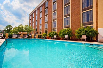 Una piscina al aire libre, tumbonas