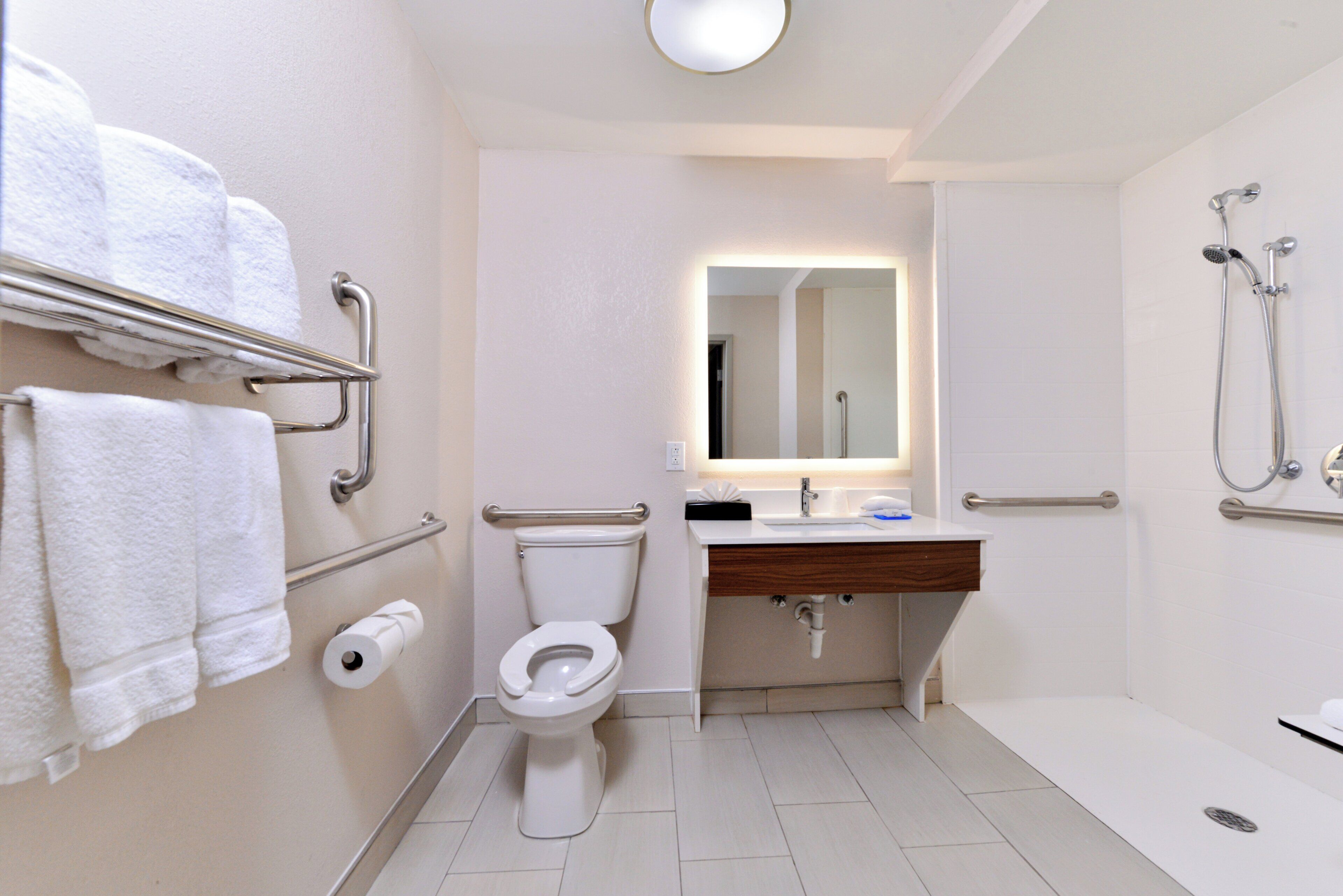 A modern bathroom with a toilet, sink, and shower.