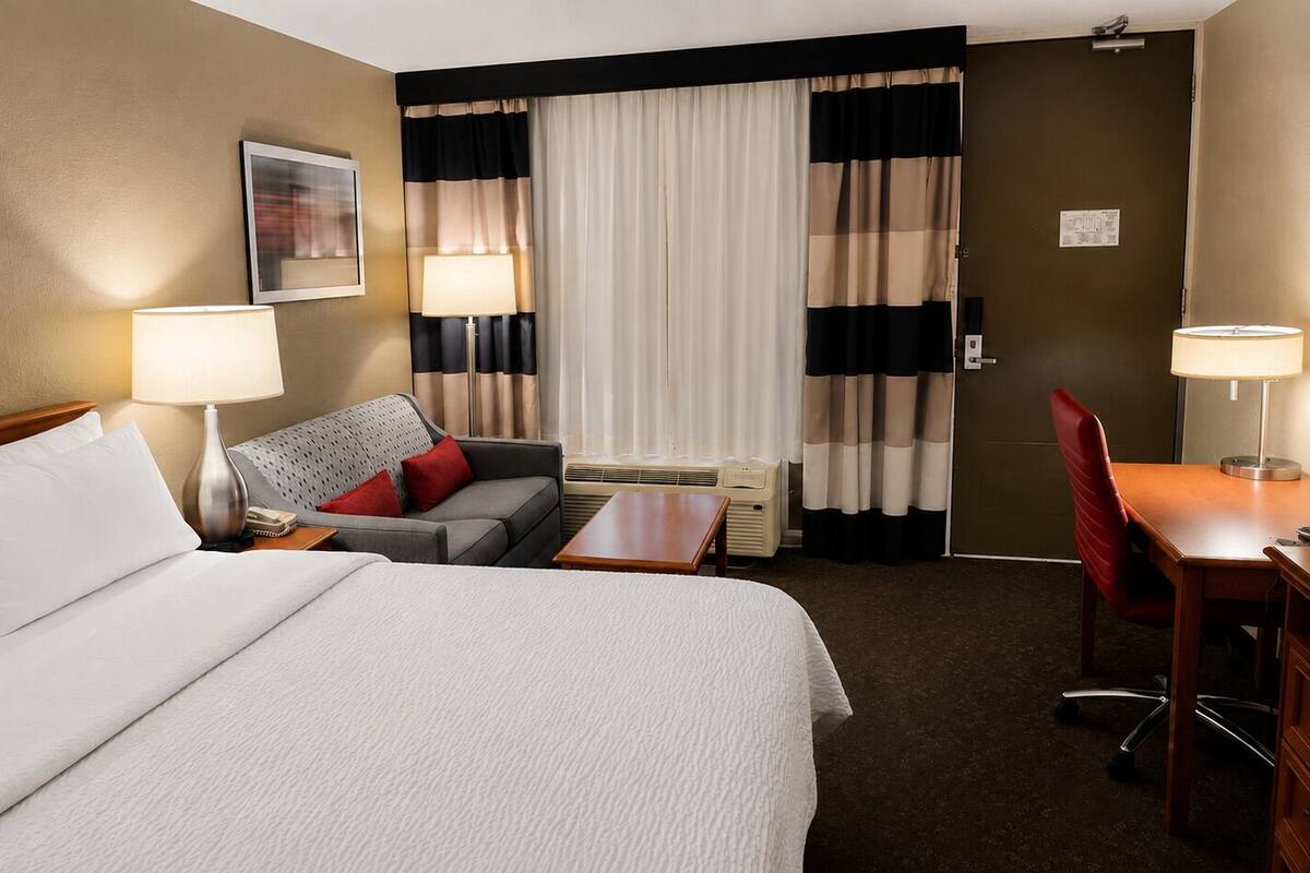 Premium bedding, desk, laptop workspace, blackout curtains