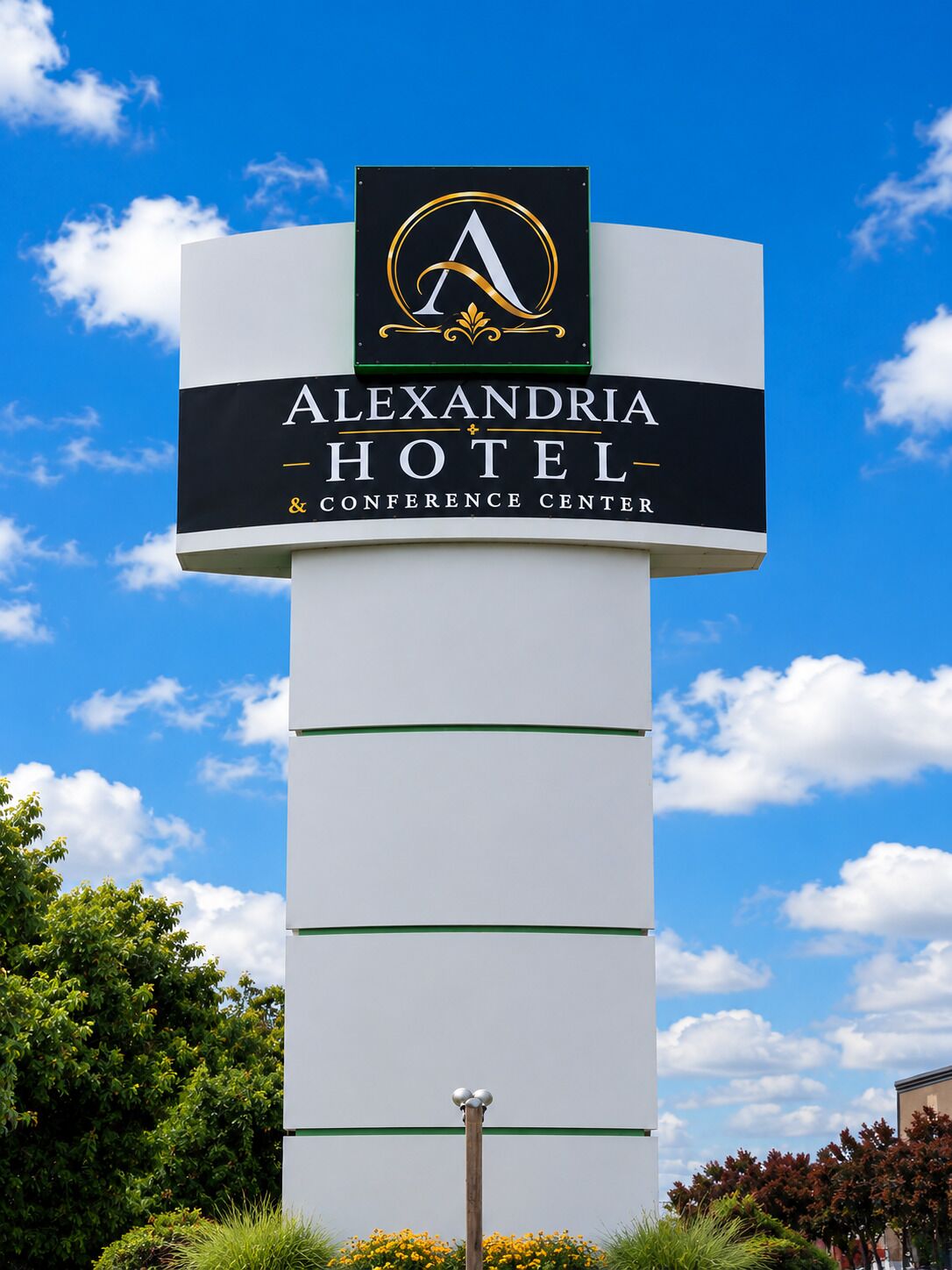 A sign for Alexandria Hotel & Conference Center with a prominent logo and name.
