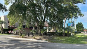 A motel with a sign indicating it is now open.