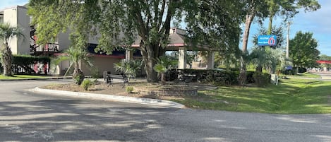 A motel with a sign indicating it is now open.