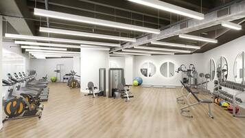 A modern gym with cardio machines, free weights, and exercise balls.