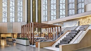 A spacious lobby with a central seating area, a staircase, and a large windowed wall. - Omni Austin Hotel (Austin)