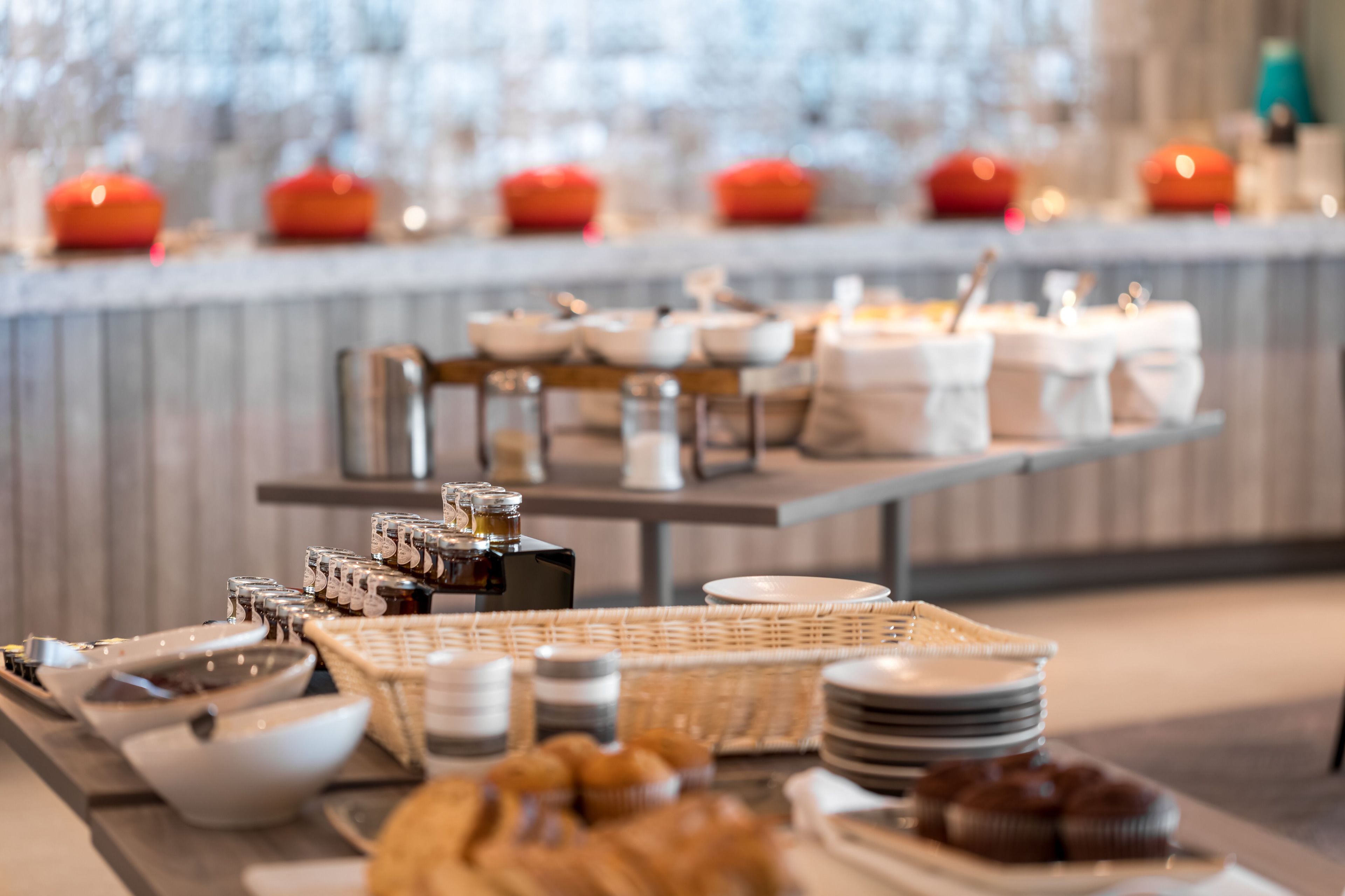 A buffet setup with various food items and condiments.