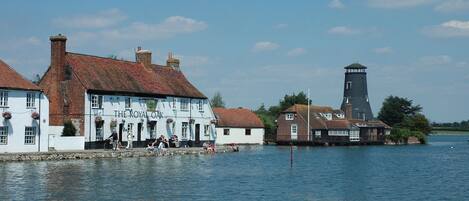 A riverside building with a sign reading "The Royal Oak."