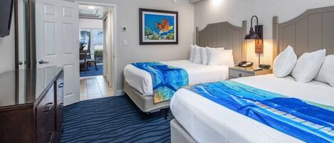 A hotel room with two beds, a desk, a chair, a TV, and a painting on the wall.