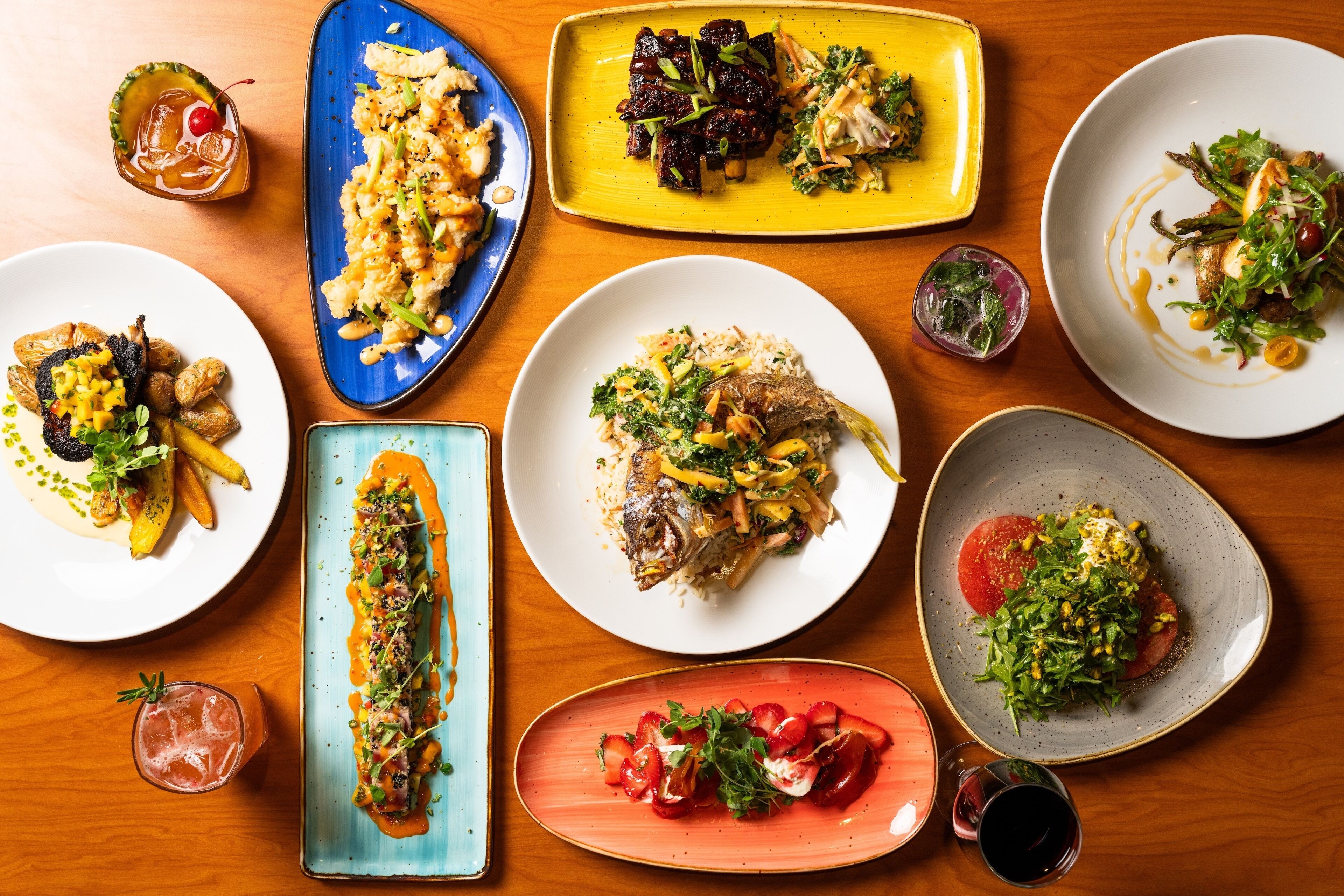 A variety of dishes on a wooden table.