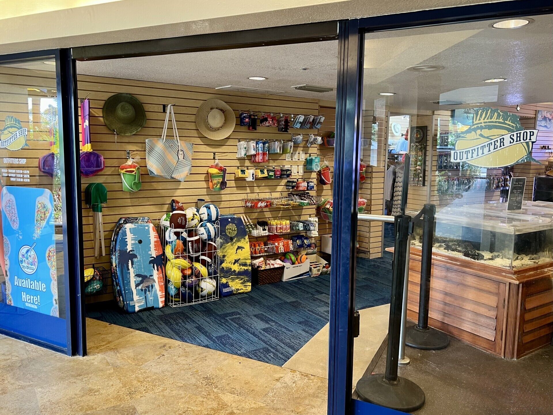 A store with a variety of sports equipment and accessories, including balls, hats, and bags.