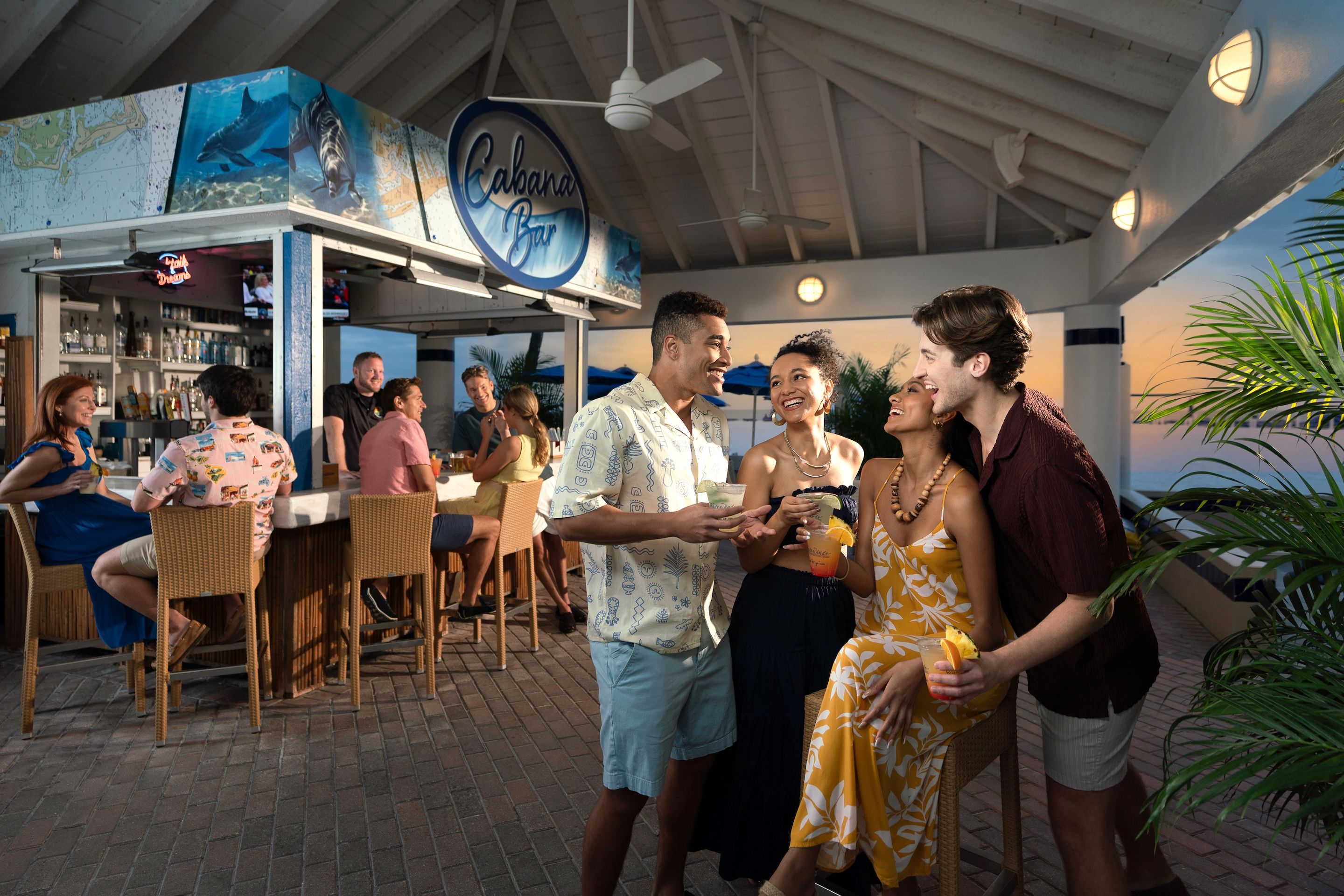 An outdoor bar area with a ceiling fan, wicker furniture, and a sign for 'Cabanas Bar'.