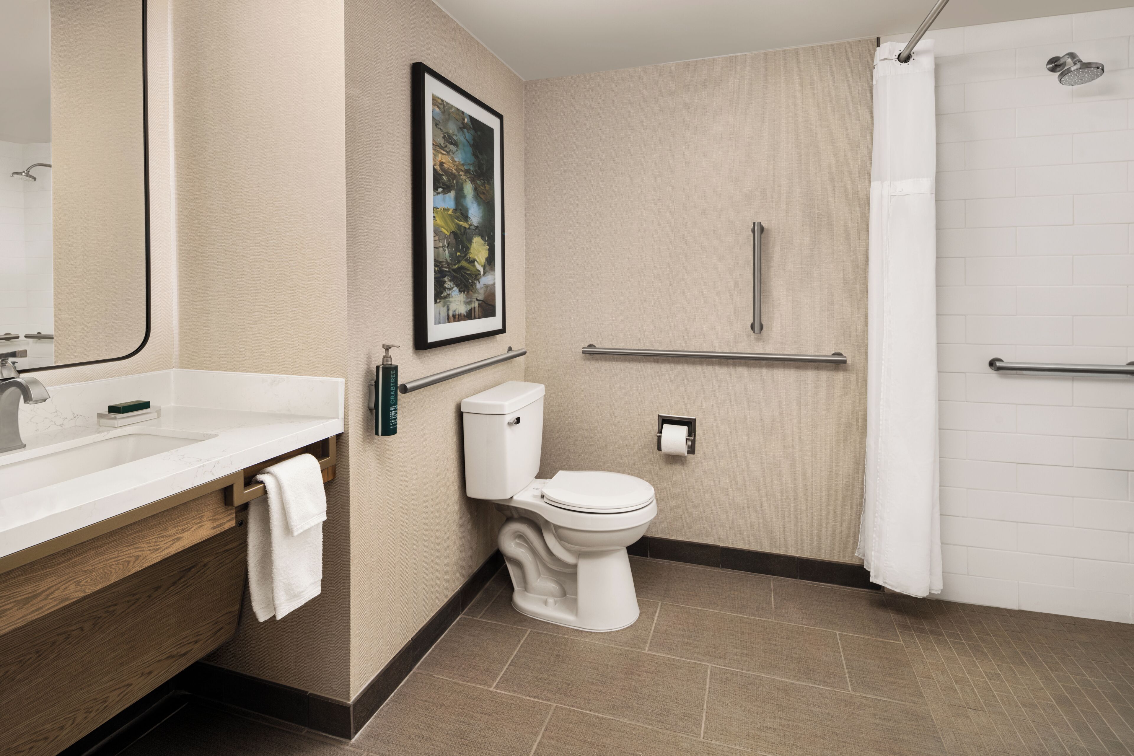 A modern bathroom with a sink, toilet, and shower.