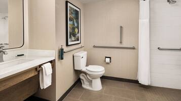 A modern bathroom with a sink, toilet, and shower.