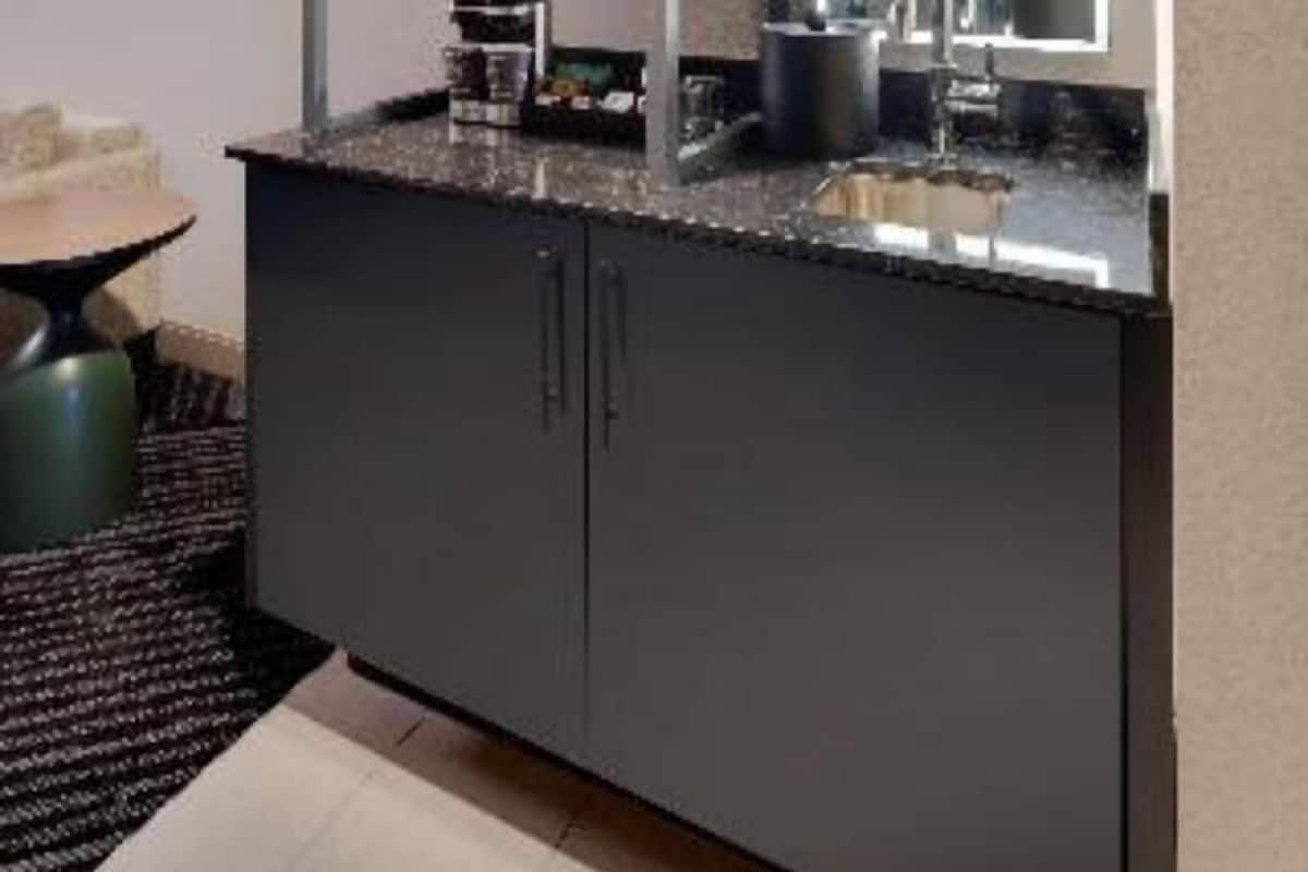 A modern kitchen with a microwave, sink, and cabinets.