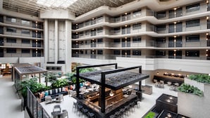 A multi-level atrium with a central open space, seating areas, and a bar/lounge with a view of the surrounding floors. - Embassy Suites by Hilton San Rafael at Marin Center (San Rafael)