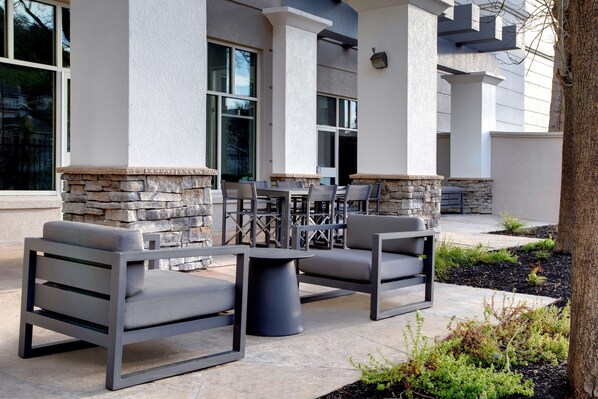 An outdoor seating area with stone accents and modern furniture.