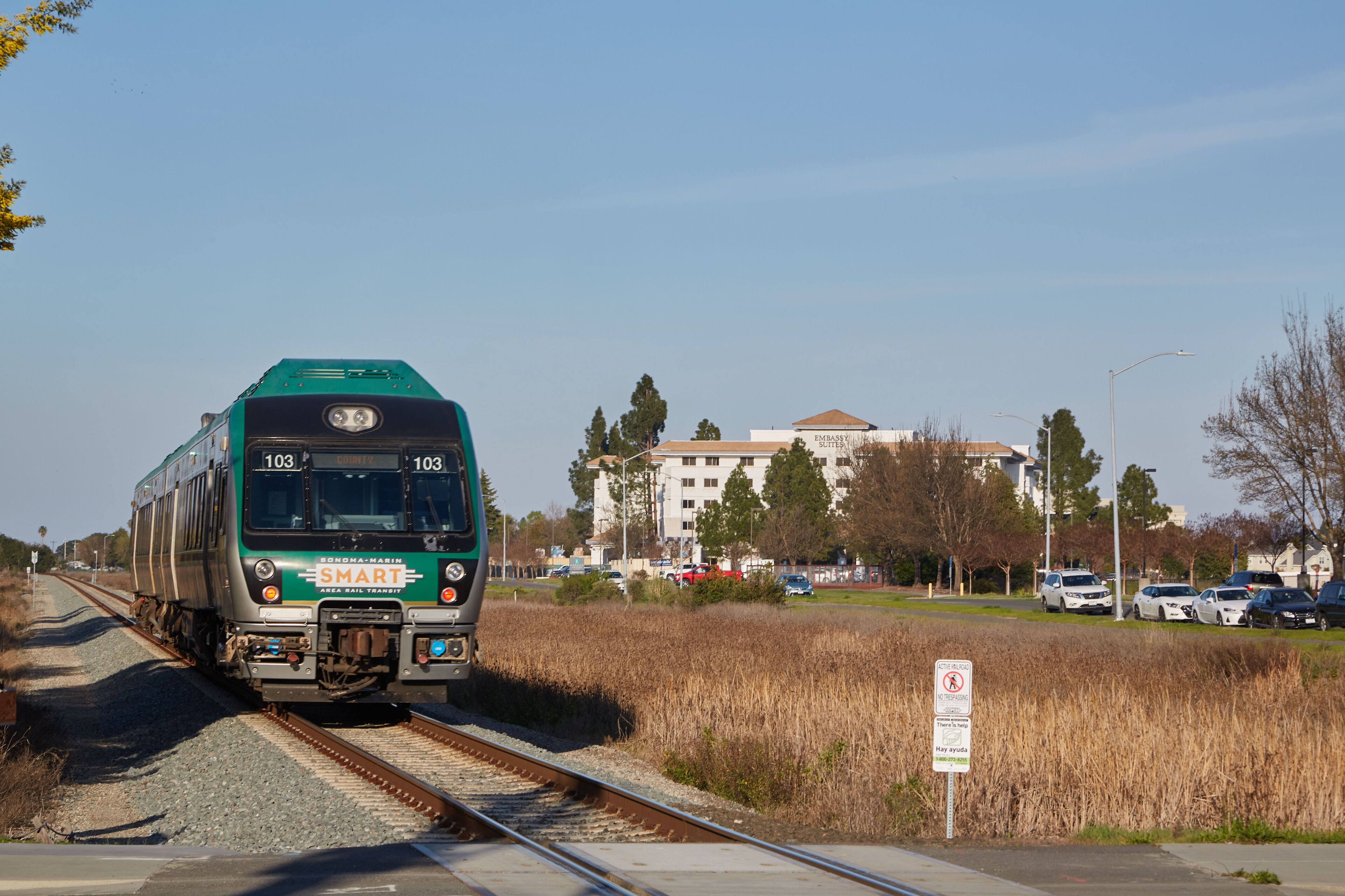 A train on tracks with a building in the background.