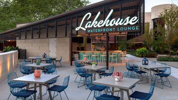 An outdoor seating area with tables and chairs at Lakehouse Waterfront Lounge.