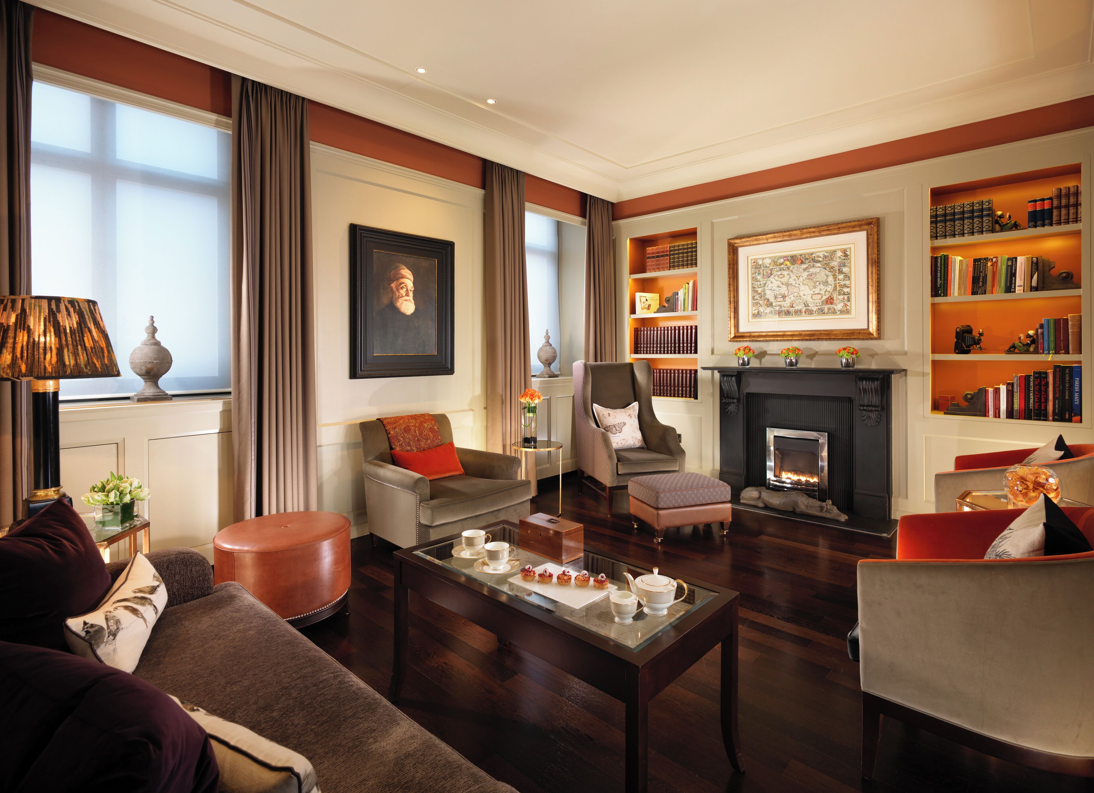 A well-appointed living room with a fireplace, bookshelves, and comfortable seating.