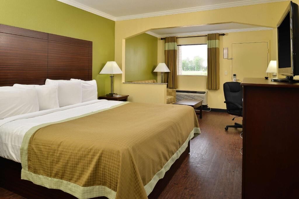 Desk, iron/ironing board, bed sheets
