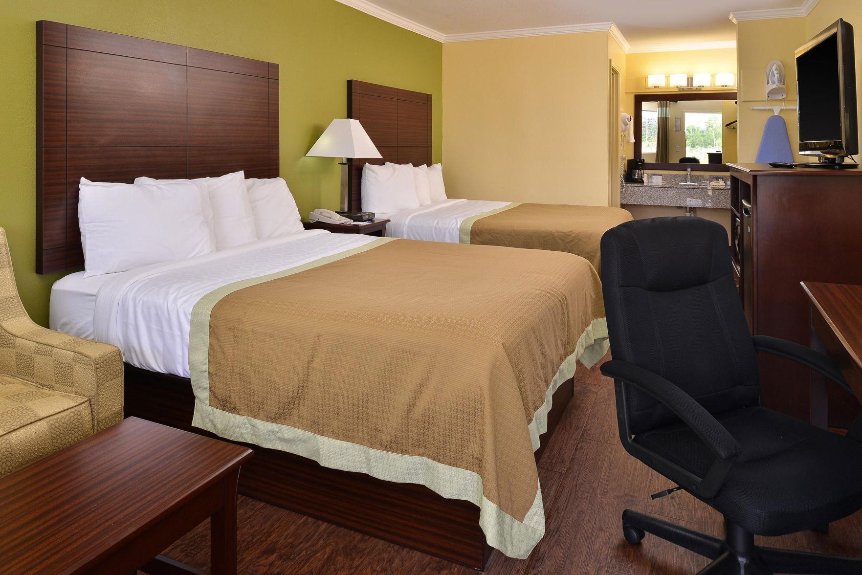 Desk, iron/ironing board, bed sheets