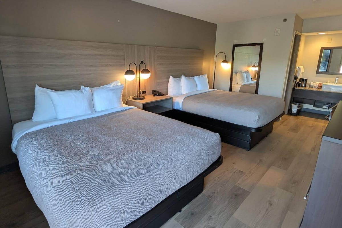 Standard Room, 2 Queen Beds, Non Smoking | Iron/ironing board, free cribs/infant beds, free WiFi, bed sheets