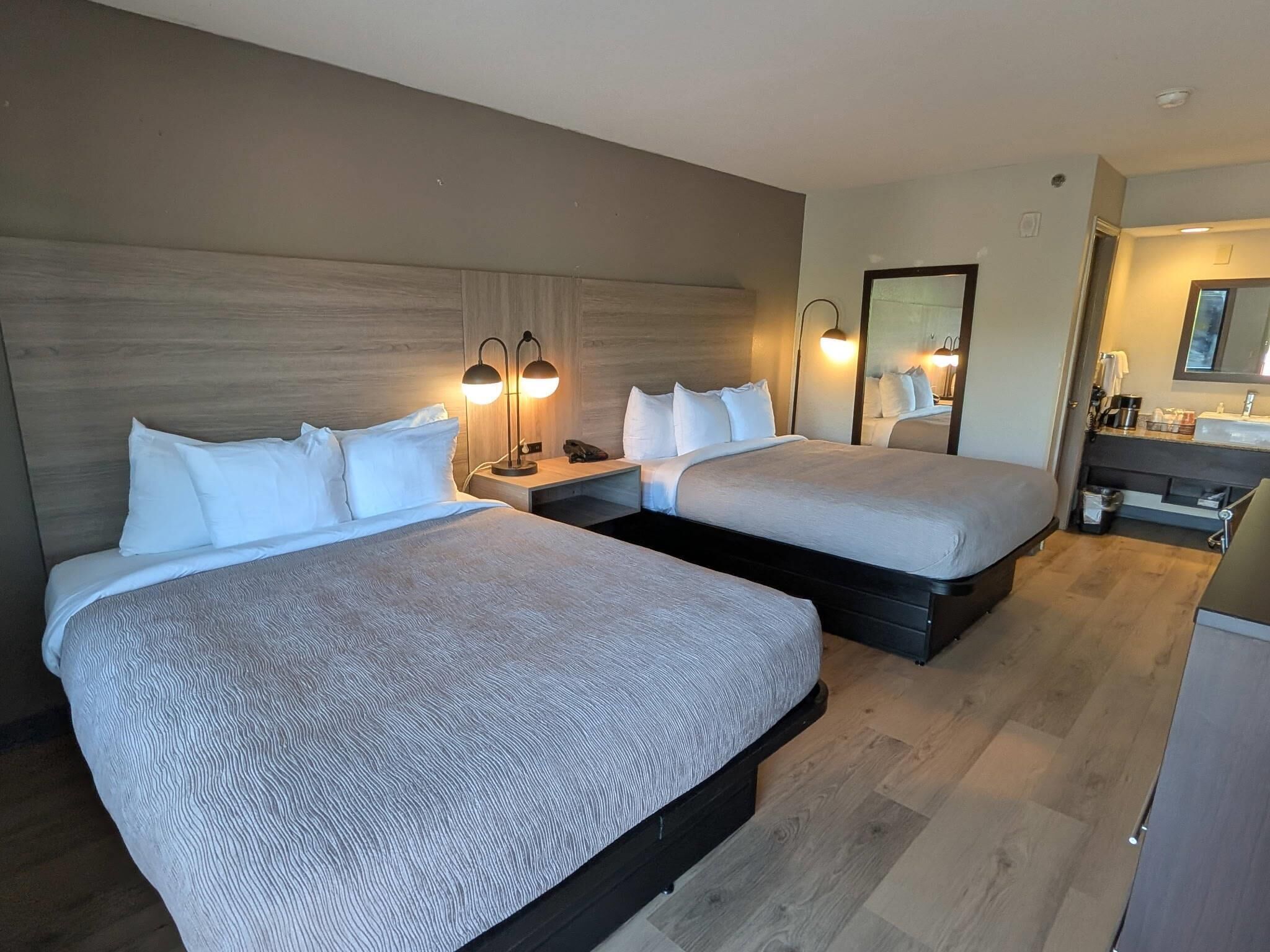 Standard Room, 2 Queen Beds, Non Smoking | Iron/ironing board, free cribs/infant beds, free WiFi, bed sheets