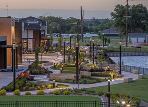 A landscaped outdoor area with pathways, seating, and a water feature. - Holiday Inn Kearney by IHG (Kearney)