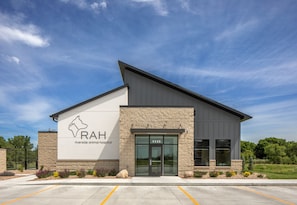 A riverside animal hospital building with a modern design, featuring a prominent logo and the name 'RAH' on the facade. - Holiday Inn Kearney by IHG (Kearney)