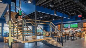 A modern interior with a staircase, seating area, and a bar.