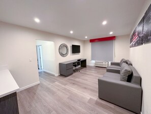Family Suite, 1 Bedroom, Non Smoking (1 Queen Bed & 1 Bunk Bed) | Desk, laptop workspace, iron/ironing board, cribs/infant beds