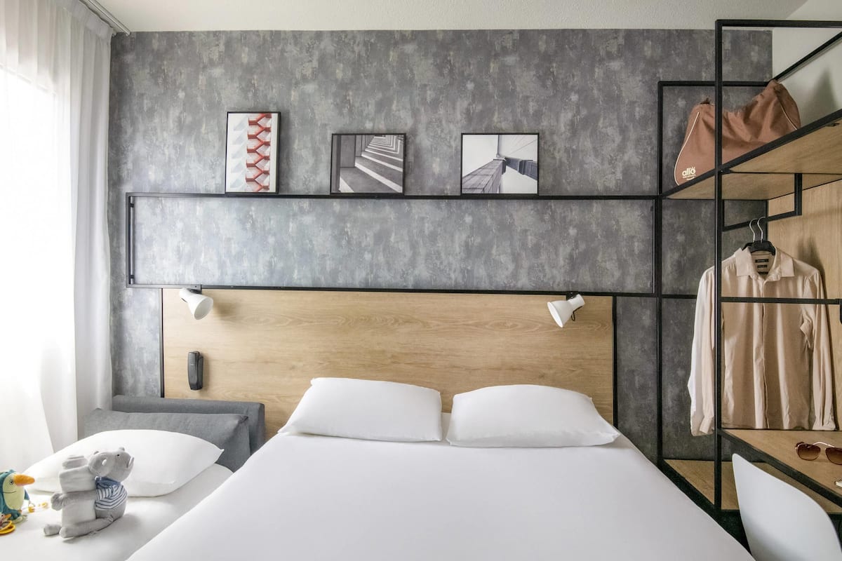 Double Room, Multiple Beds | In-room safe, individually decorated, desk, blackout drapes