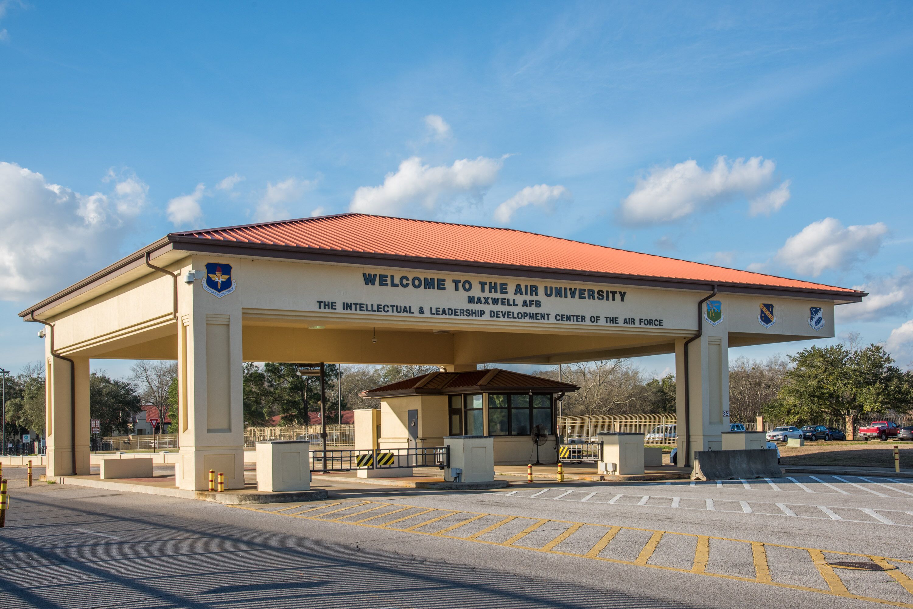 A building with a red roof and a sign that reads "Welcome to the Air University."