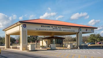 A building with a red roof and a sign that reads "Welcome to the Air University."