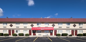 A Red Roof Inn with a red awning, multiple windows, and a parking lot. - Red Roof Inn Dayton - Huber Heights (Dayton)