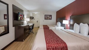 A hotel room with two beds, a desk, a chair, a TV, and a mirror. - Red Roof Inn Dayton - Huber Heights (Dayton)