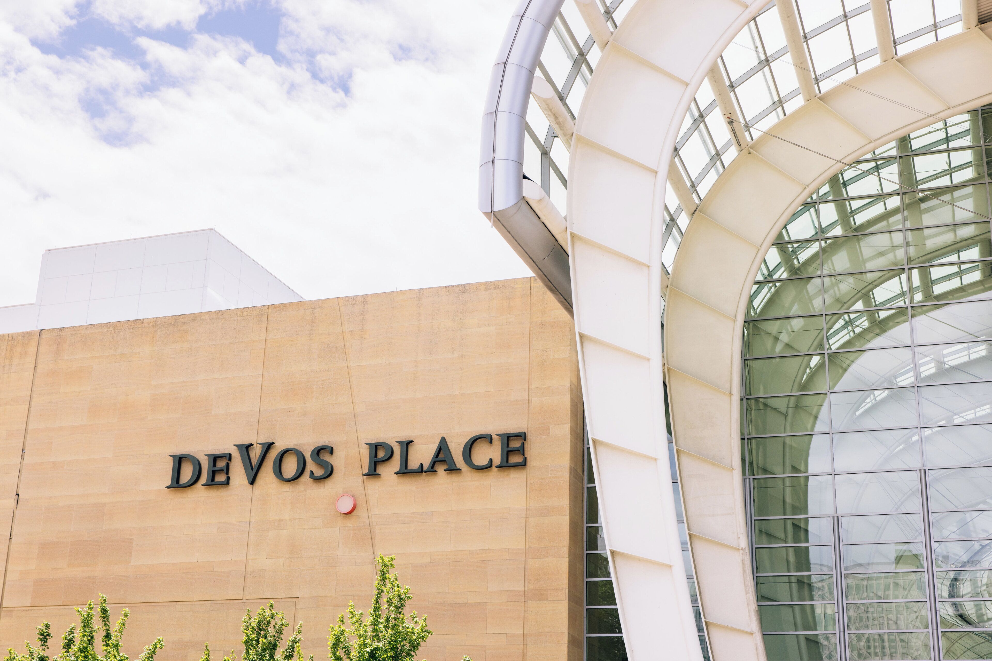 A building with a sign reading "DEVOS PLACE" and a large glass window structure.