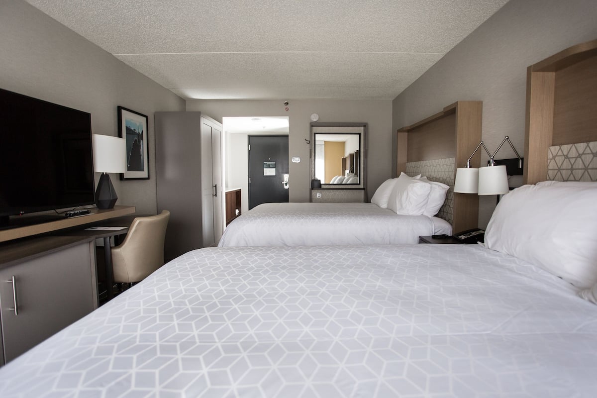 Hypo-allergenic bedding, desk, laptop workspace, blackout drapes