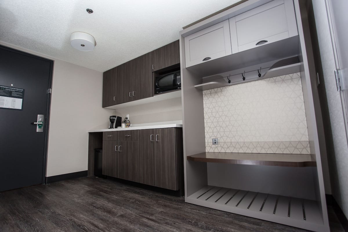 Hypo-allergenic bedding, desk, laptop workspace, blackout drapes