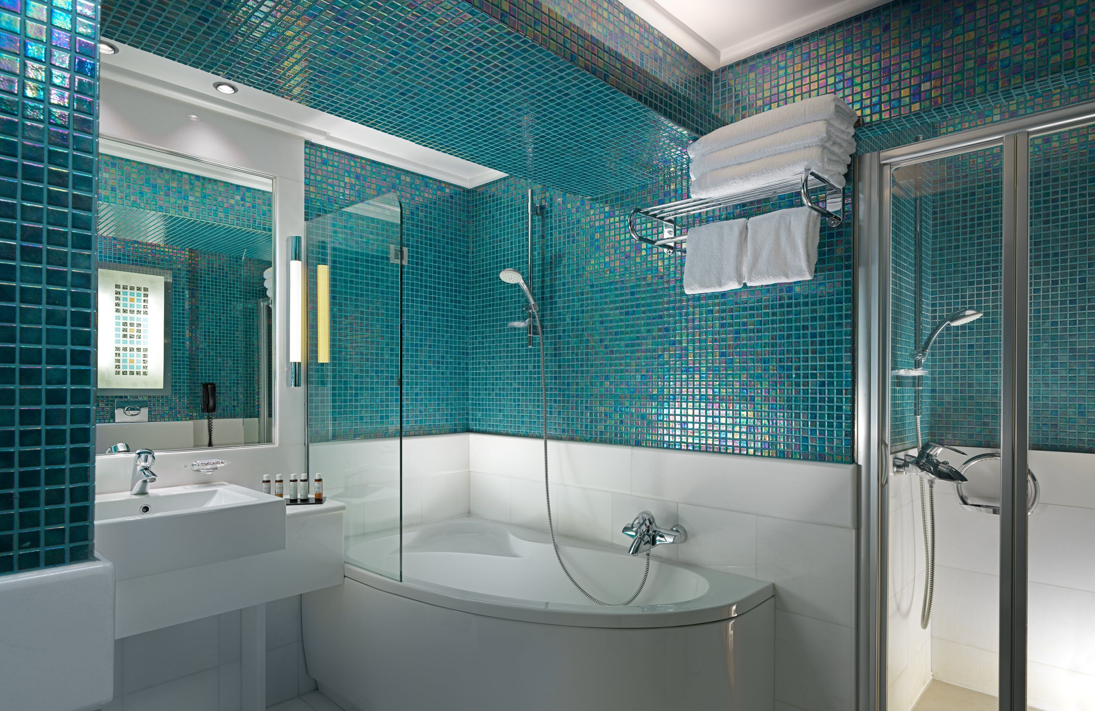 designer toiletries, hair dryer, bathrobes, slippers