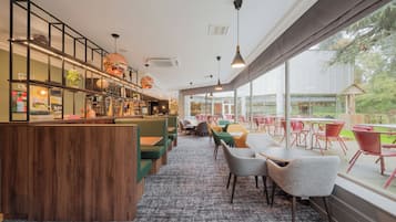 Relax in a stylish space with comfortable seating options, including booths and tables, and enjoy the view from the large window.