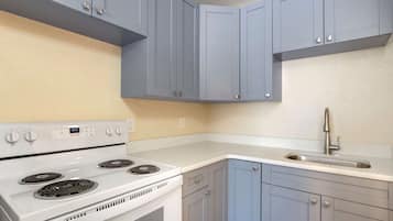 Suite, 1 King Bed, Non Smoking (Efficiency) | Desk, blackout drapes, iron/ironing board, free cribs/infant beds